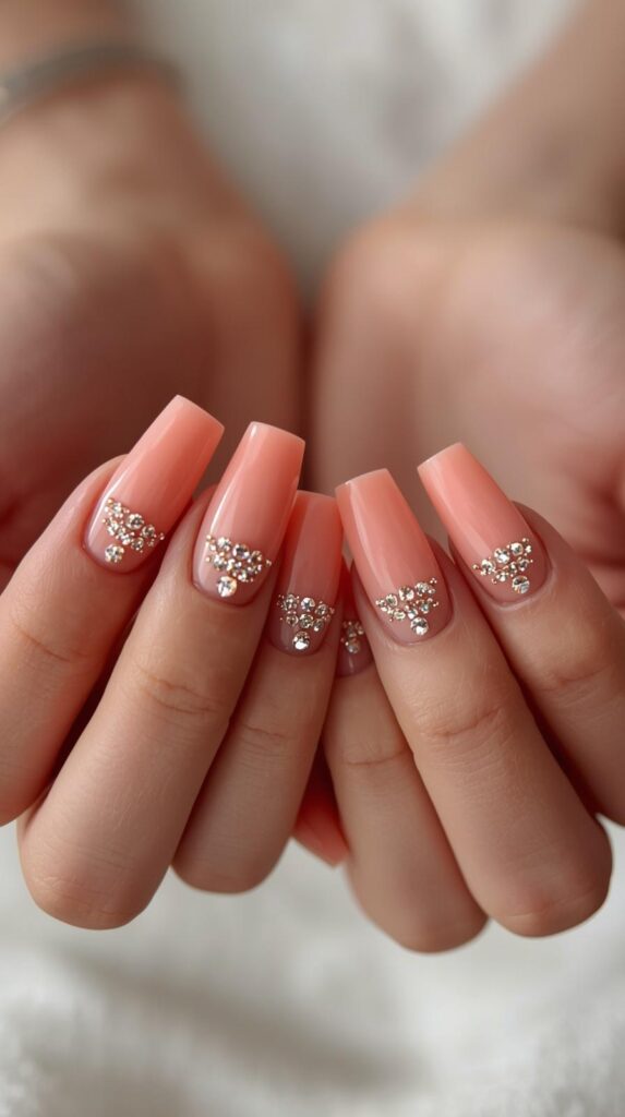 6. Peach Coral Nails with Rhinestone Accents