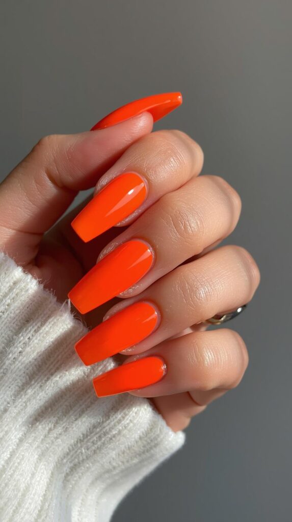 11. Bold Orange Nails